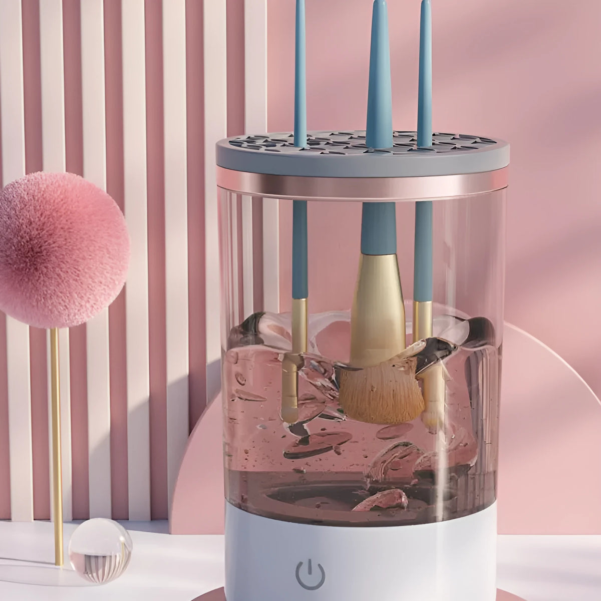 Grey and white portable electric makeup brush cleaner with USB charging cable.