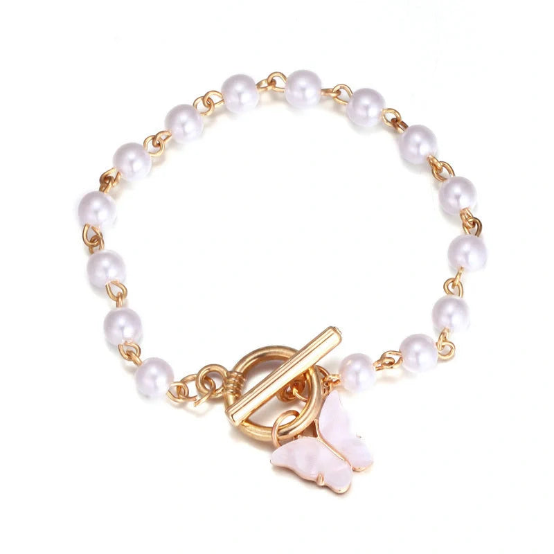 Gold charm bracelet with pearl and butterfly design for women
