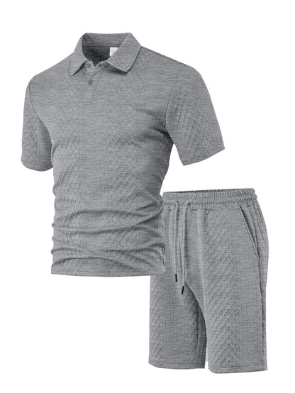 Men's patterned cloth casual suit set with short sleeve polo top and trousers on a hanger.