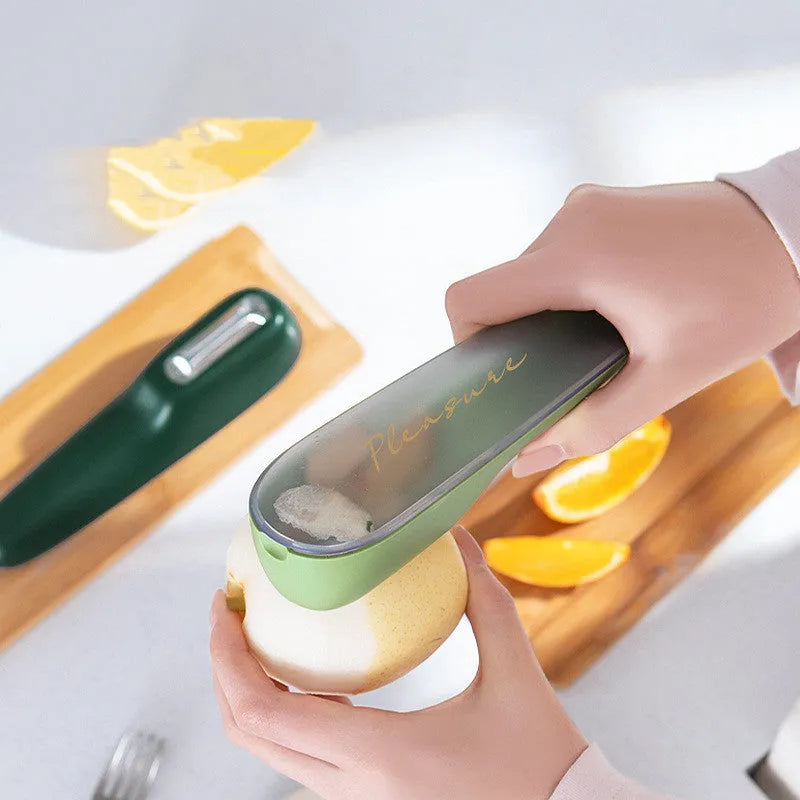 Dark green and light green kitchen peeler with storage tube and stainless steel blade