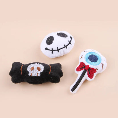 Plush cat teaser wand with candy, eyes, and skull heads on a 40cm string next to a wand handle.