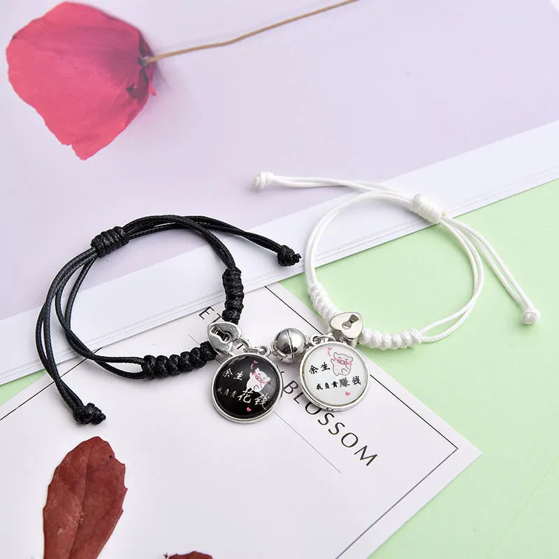 Magnetic suction couple bracelet pair in alloy with an electroplated finish, showing example designs like a crown and love lock.