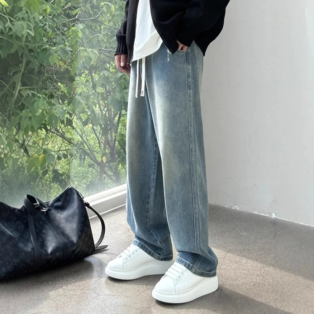 Straight-leg loose fit men's jeans in blue denim with drawstring waist for casual spring summer wear
