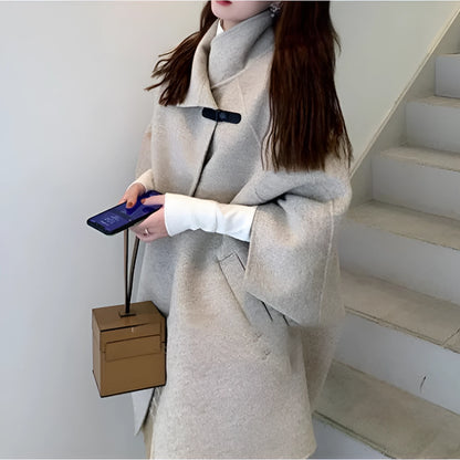 Long-length women's Korean-style acrylic coat in oatmeal colour with flight sleeves.