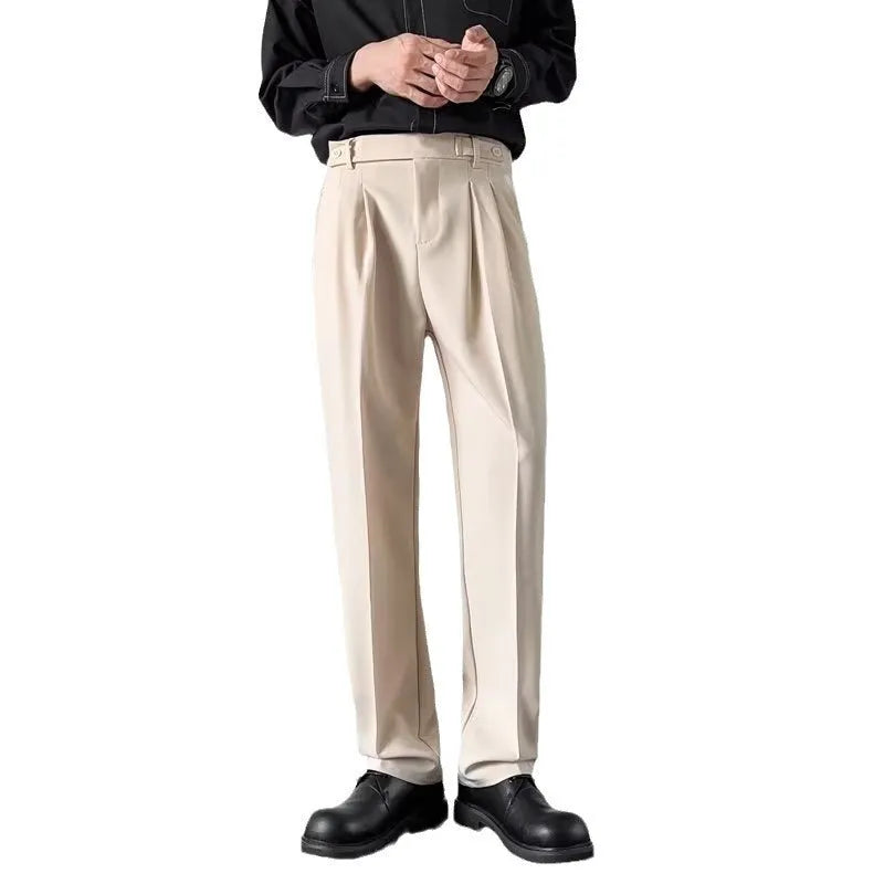 Men's apricot and black straight-leg loose fit suit trousers on a hanger.