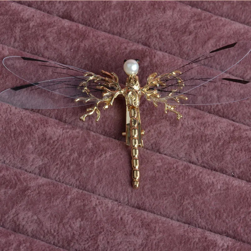 Women's dragonfly side clip headdress in electroplated alloy with golden finish, a decorative hair accessory featuring a detailed dragonfly design for festival and occasion wear, supplied as a single piece.