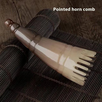Black half-moon shaped buffalo horn comb with wide teeth for scalp massage and detangling hair.