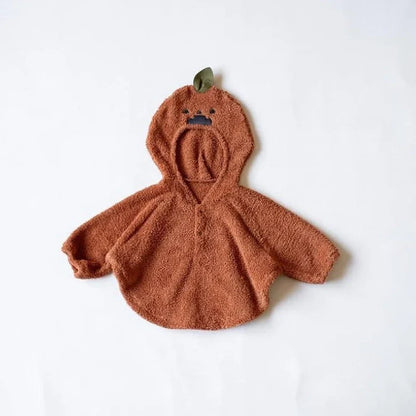 Baby wearing festival-themed plush top with hood and long sleeves in fleece fabric