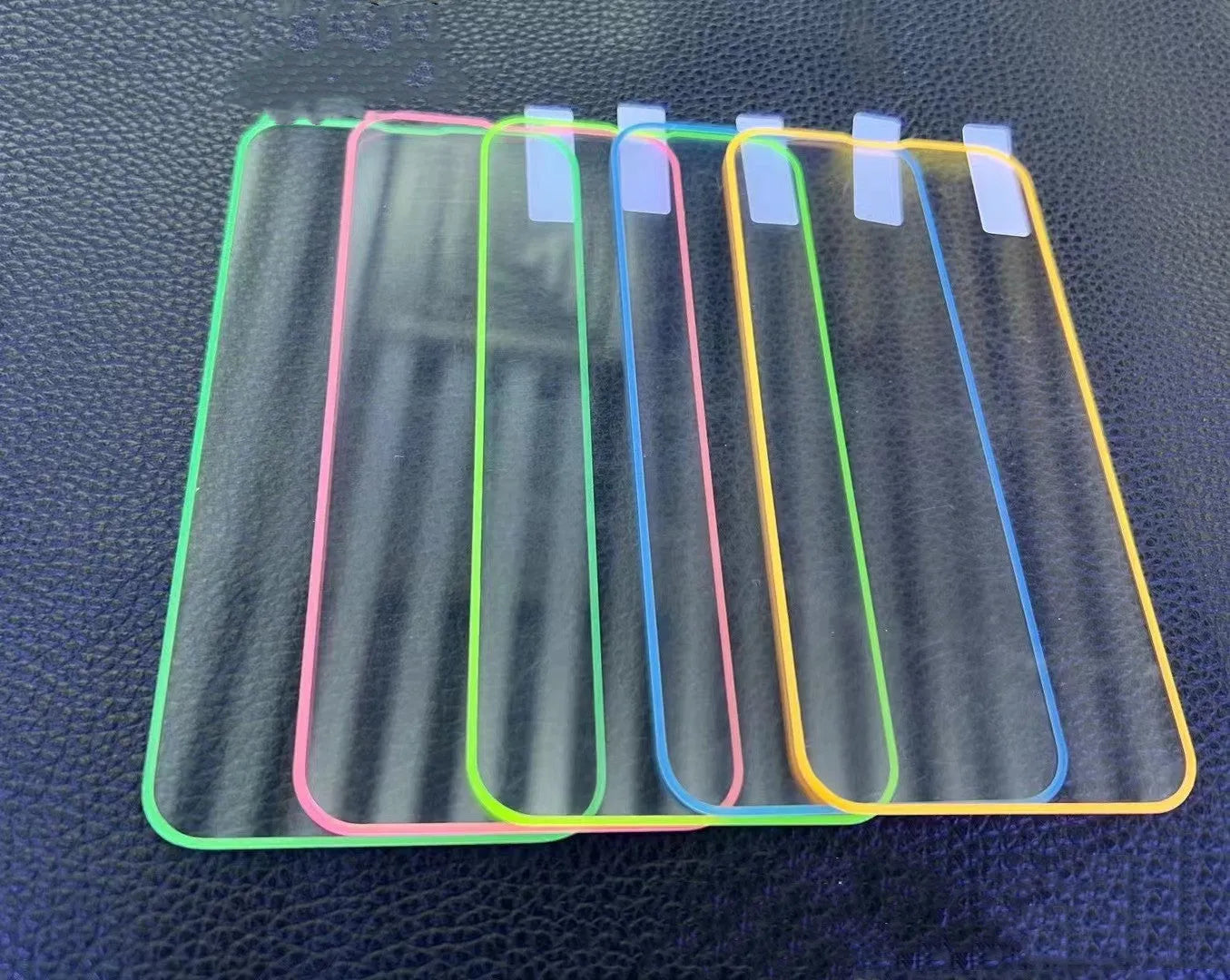 Fluorescent tempered glass screen protector glowing in blue for iPhone with full-screen coverage