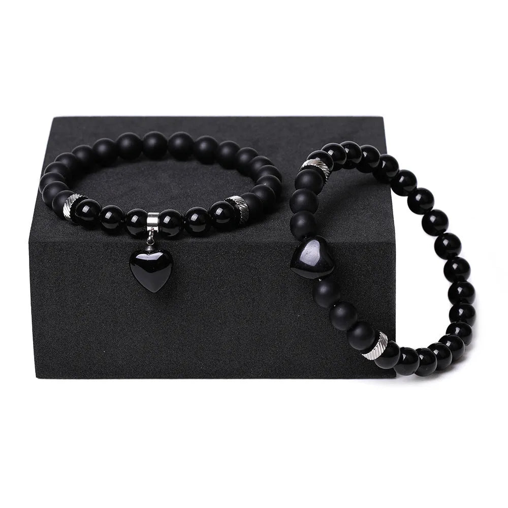 Matching couple bracelets with polished natural stone heart pendants in geometric style