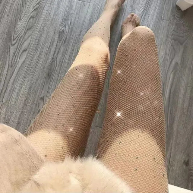 Women's fishnet stockings with diamond mesh pattern in skin colour, laid flat