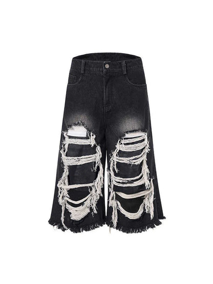 Black cropped wide-leg jeans with a mid-high waist, ripped patch detail, and a loose fit on a model.