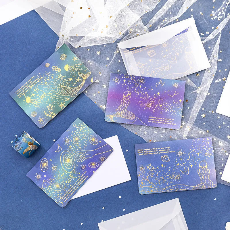 Set of three bronzing detail greeting card envelopes in cosmic colours, showing mermaid style fold.