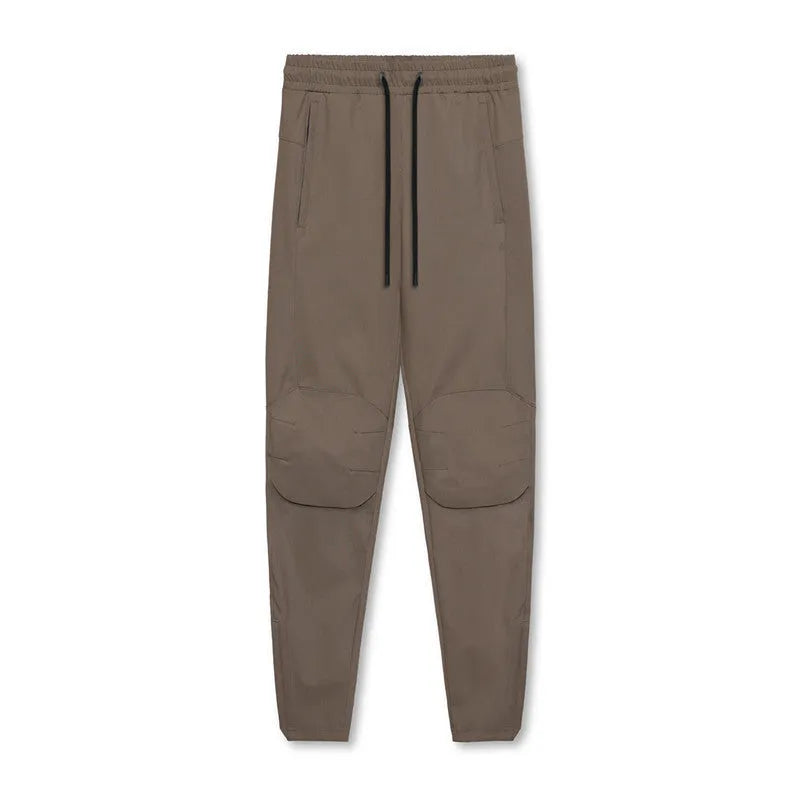 Men's grey fitness trousers with ankle ties, made from quick-drying polyester, for exercise and casual use.