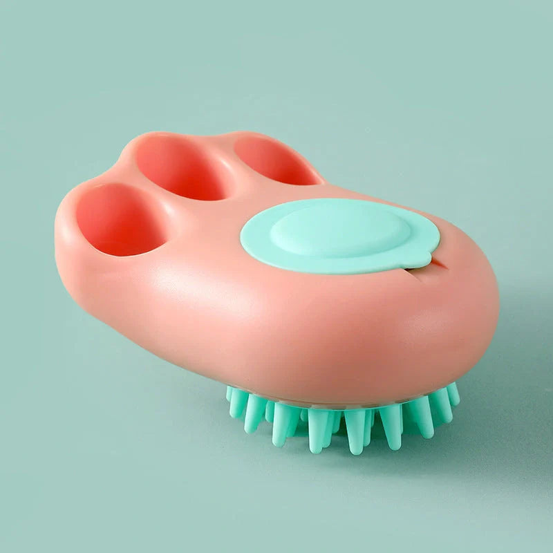 Claw-shaped pet grooming brush in pink, blue, yellow, and grey