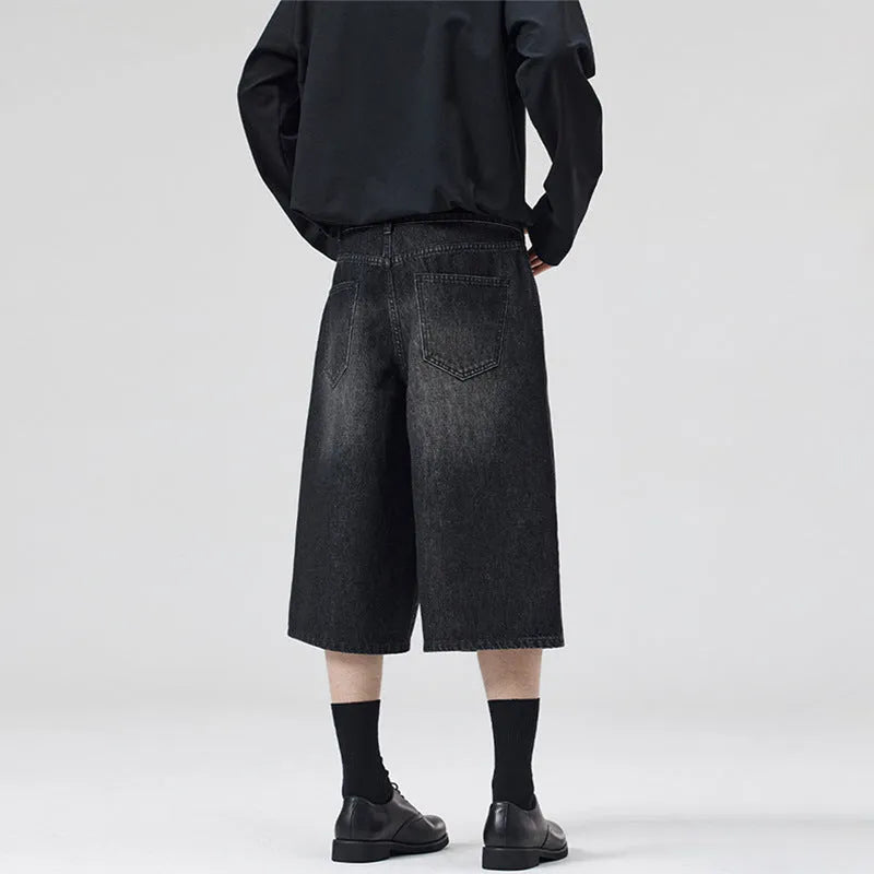 Men's loose straight denim shorts in light blue with cropped length ending above ankle, straight-leg cut