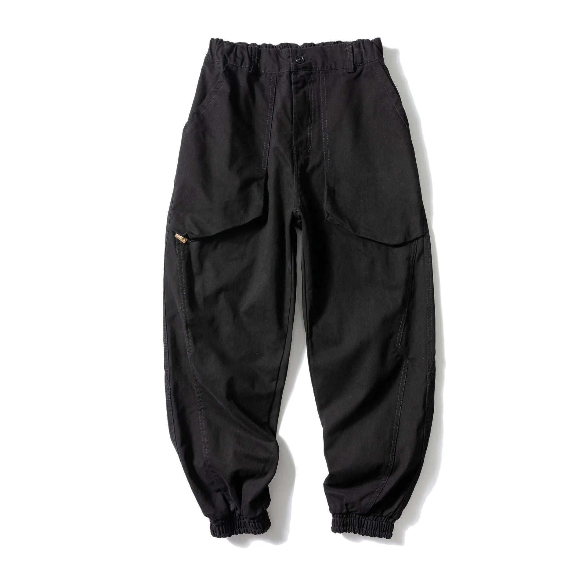 Black cotton casual pants with large pockets, tapered legs, and ankle ties on a hanger.