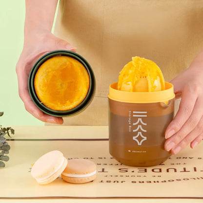 Green manual citrus juicer with lemon on counter, showing compact 180mm size.