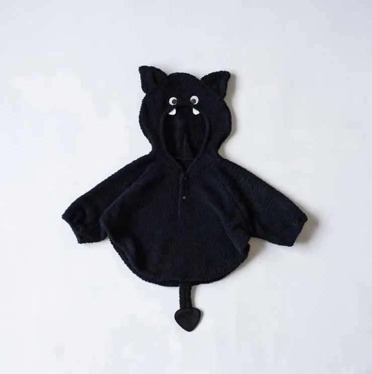 Baby wearing festival-themed plush top with hood and long sleeves in fleece fabric