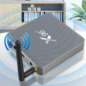 Android smart TV set-top box with remote control and HDMI cable on a wooden surface.