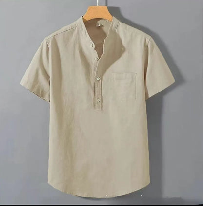 Man wearing a beige loose-fit linen blend casual shirt with a stand collar and short sleeves.