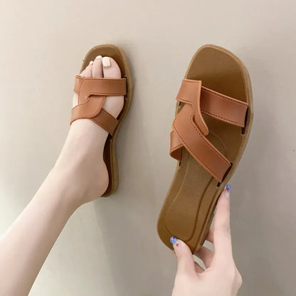 Women's PVC toe ring slippers with a cross strap in milky white, shown from a side angle.