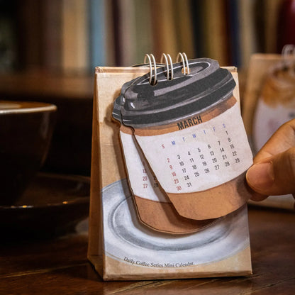 2025 mini desk calendar showing one of four designs: Coffee Time, Awake Time, Corner Perching, or Afternoon Lazy.