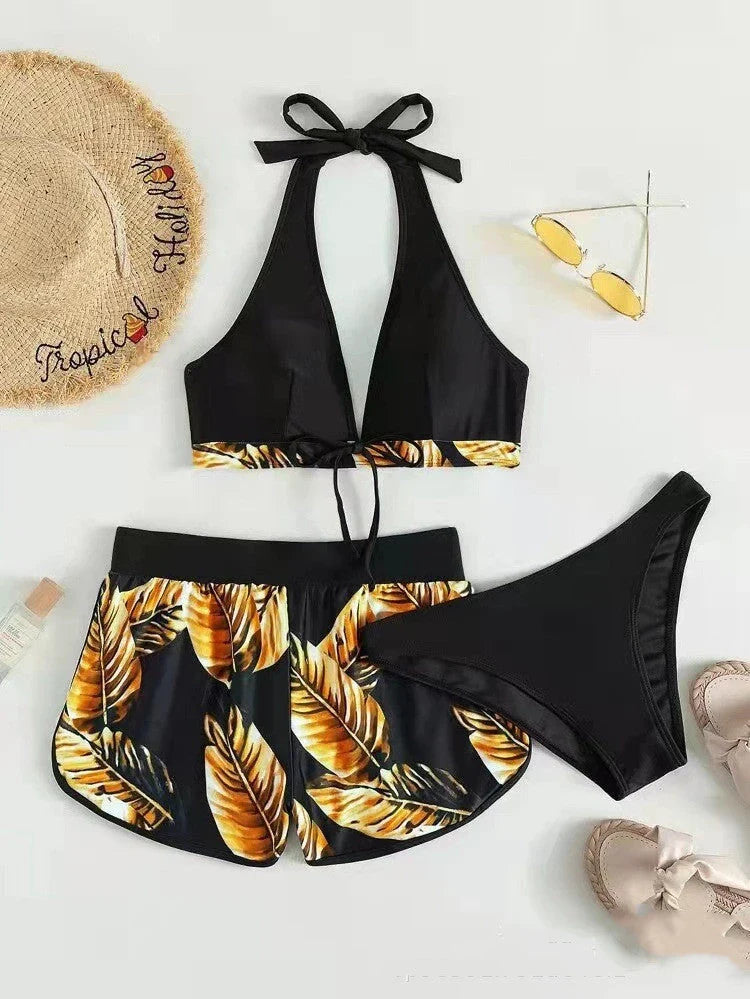 A stylish 3-piece swimsuit set featuring a unique leaf print design, including a top, bottoms, and matching shorts.