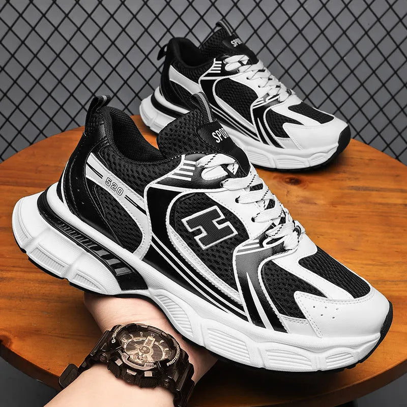 Men's mesh running shoes with injection-moulded plastic soles, available in sizes 39-45, suitable for casual wear and sports. Round-toe design with solid colour options including black, white and grey, and white orange.