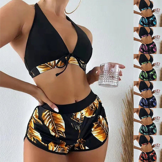 A stylish 3-piece swimsuit set featuring a unique leaf print design, including a top, bottoms, and matching shorts.