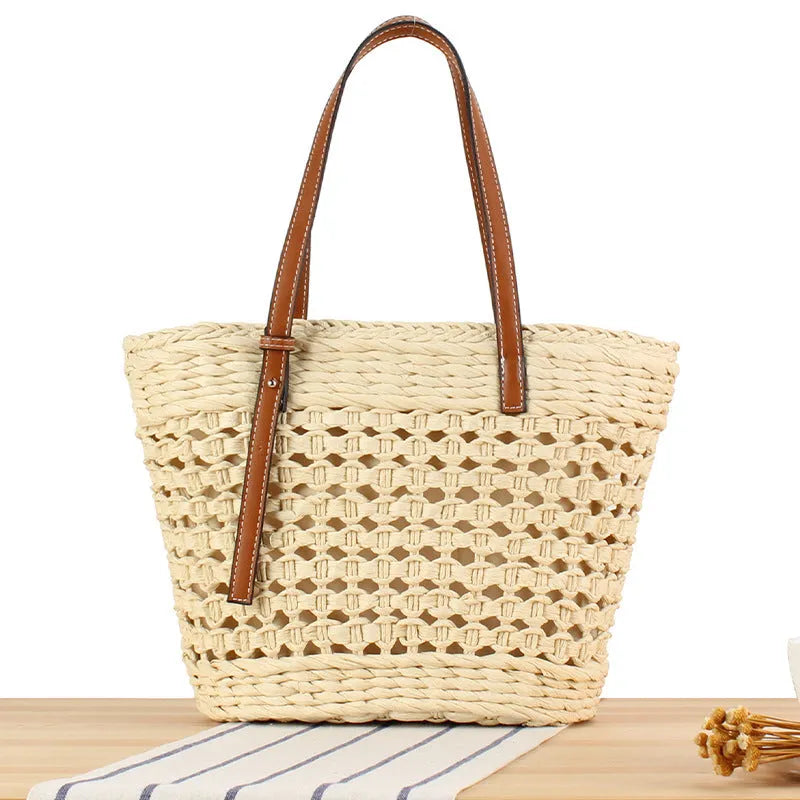 Beige woven paper-string shoulder bag with horizontal square shape and adjustable strap