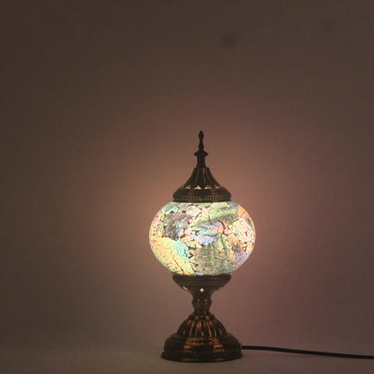 Glass table lamp with 150mm diameter shade and 330cm cord on wooden surface