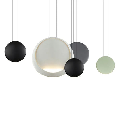 Round resin cosmos chandelier light with adjustable hanging height, shown in a bedroom setting.