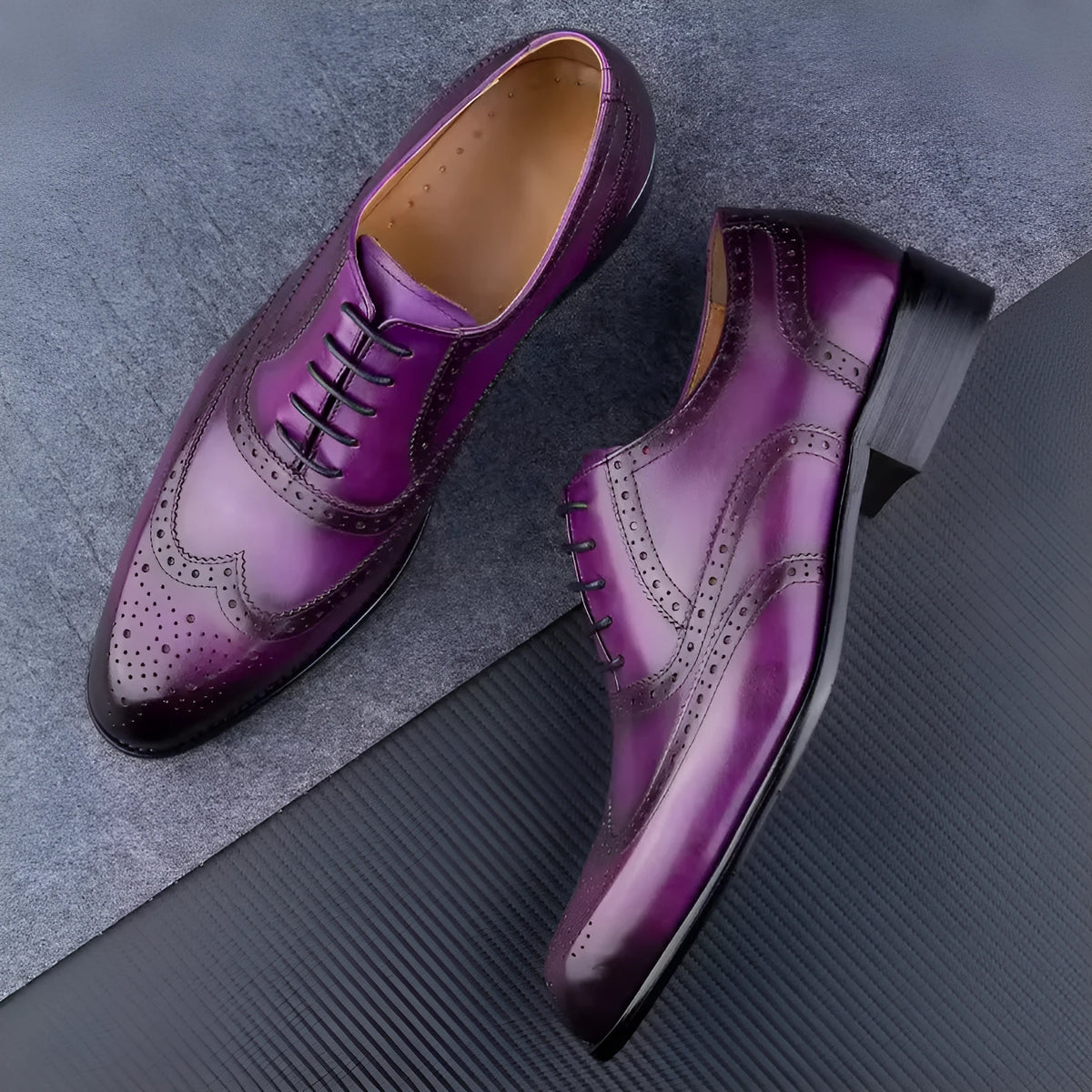 Men's purple leather Oxford shoes with hand-carved design and pointed toe on a rubber sole.