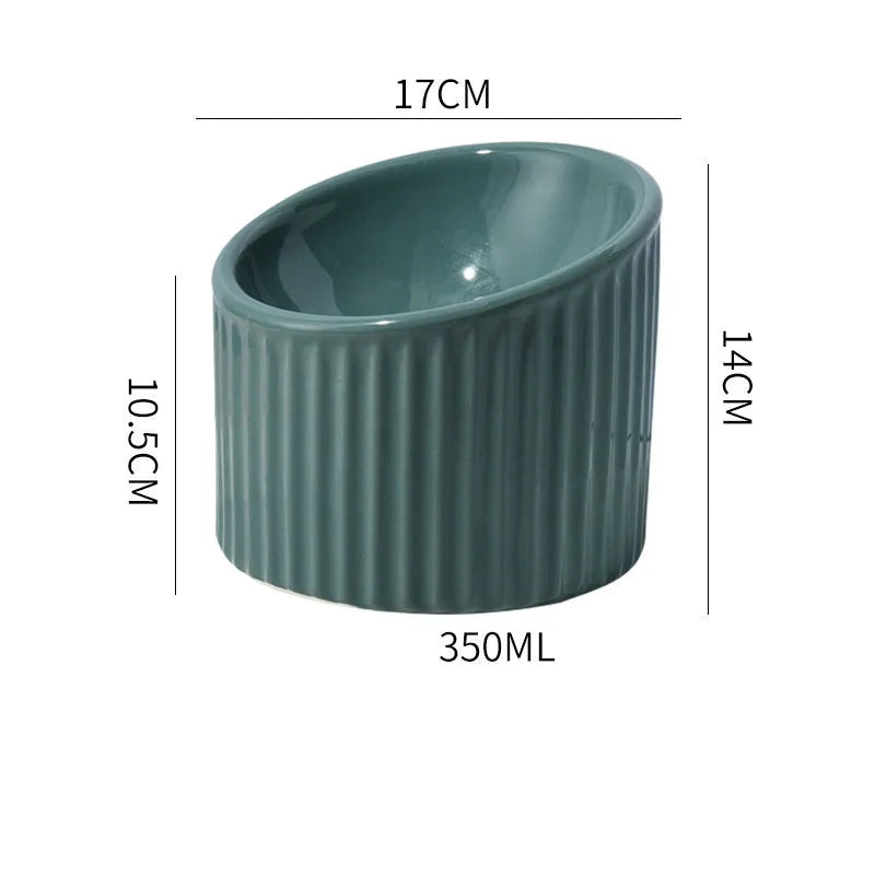 Ceramic raised cat bowl in light green, showing elevated tilted design for pet feeding.