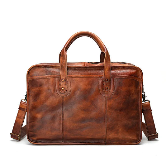Brown leather briefcase showing internal compartments including laptop pocket and document sections