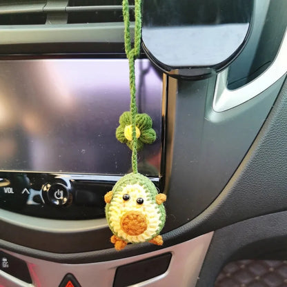 Handmade crocheted cartoon-style car pendant in wool, shown in avocado, pink rainbow, and red rainbow colour options.