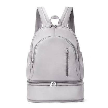 Women's casual backpack in black with adjustable curved shoulder straps and contrast stitching, 20-35L waterproof polyester.