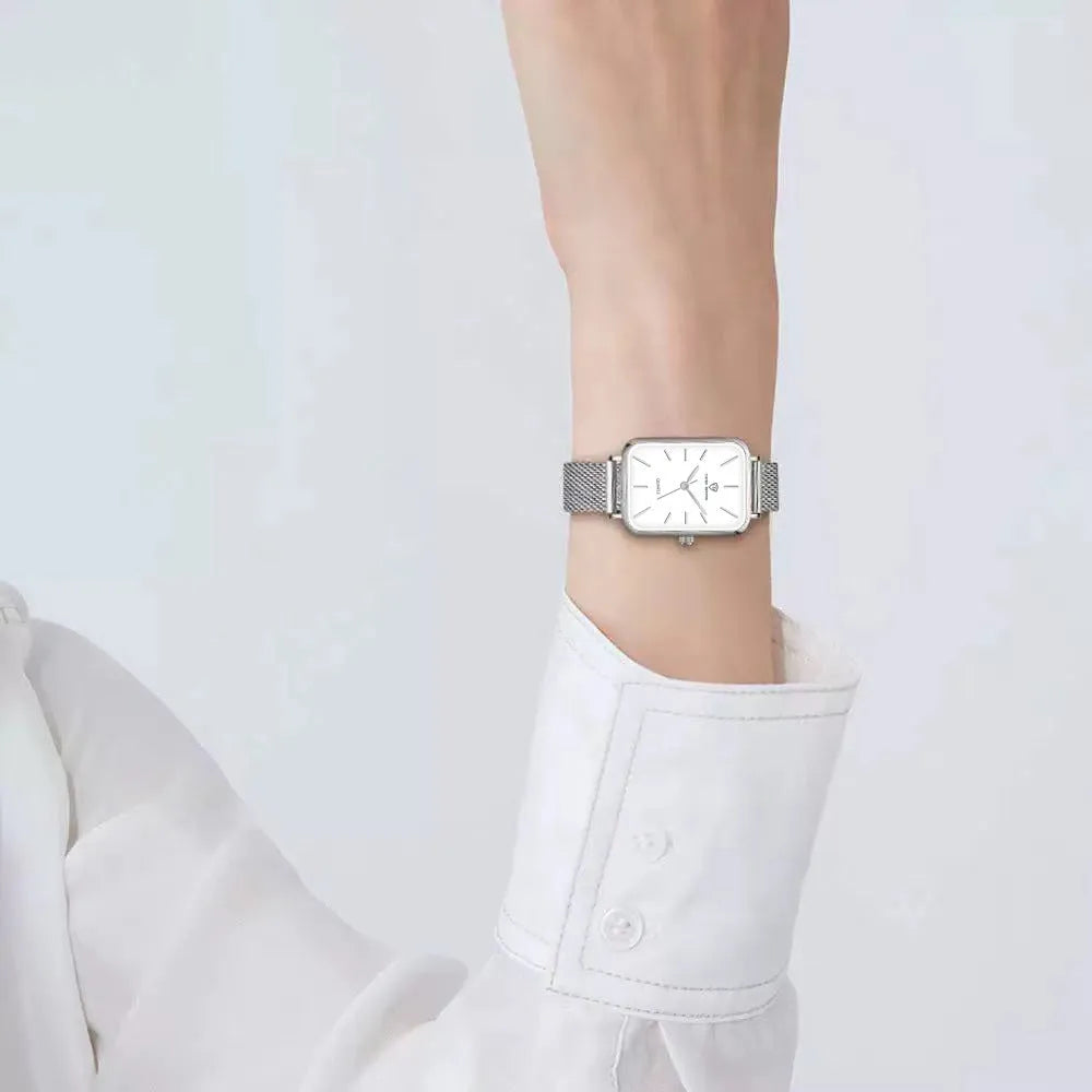 Women's waterproof quartz watch with rose gold alloy case and woven steel strap on wrist