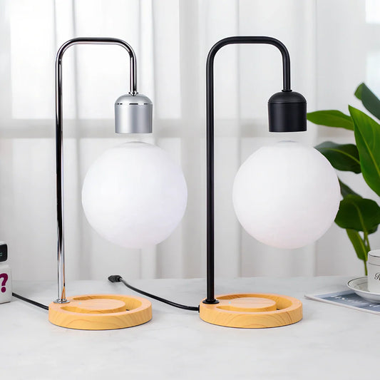 Magnetic levitation table lamp with floating light element and wooden base showing wireless charging capability