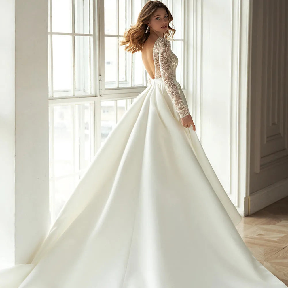 White long-sleeved mid-waist dress with gilded hollow-out detailing, shown in full length.