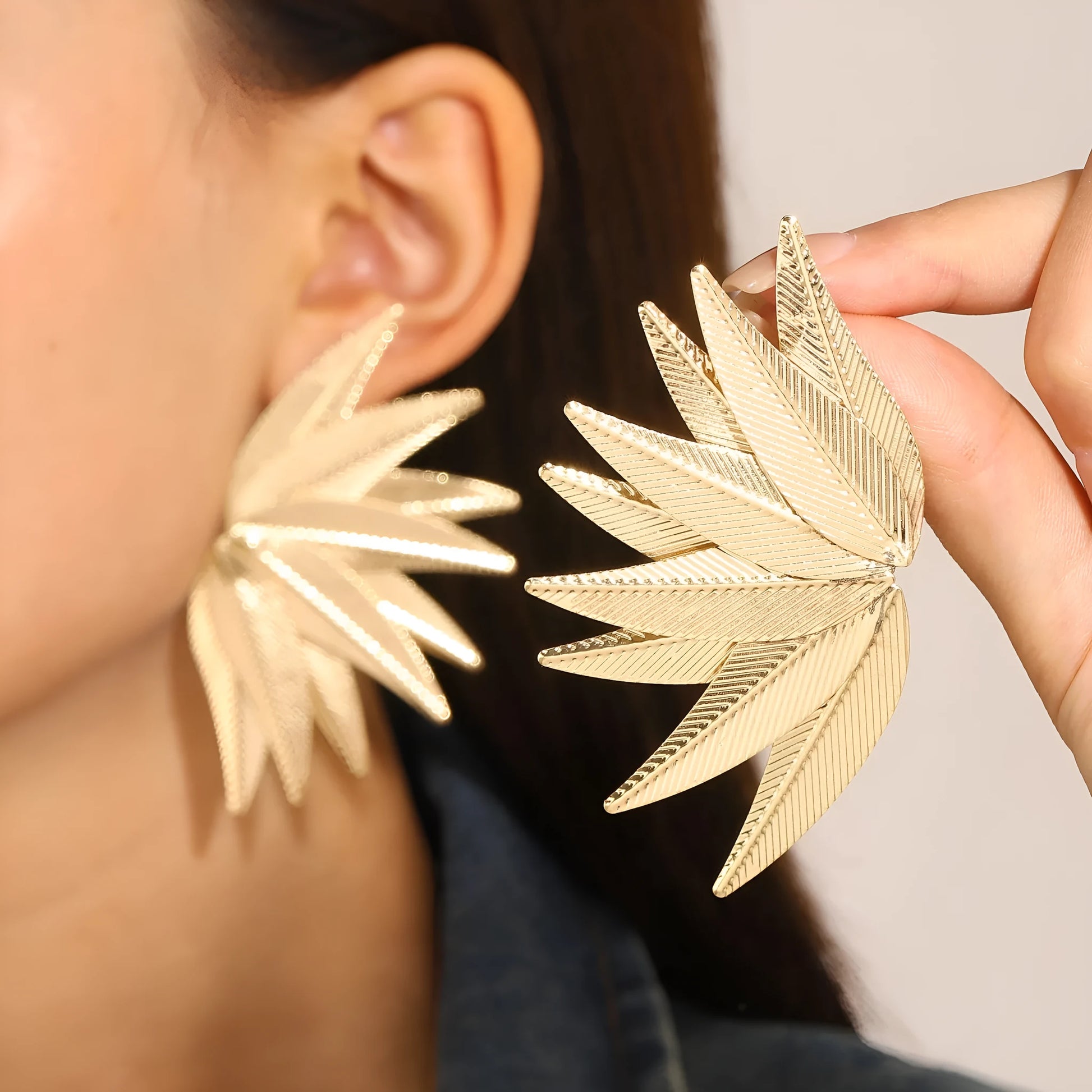 Gold and white alloy leaf-shaped patch earrings with dangle design