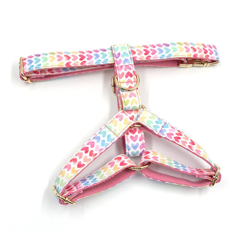 Pink colourful dog harness with heart-shaped stones and gold buckle in chest and back strap design