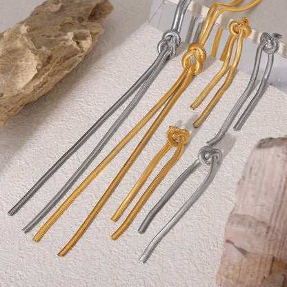 Gold electroplated titanium steel knotted tassel necklace and matching earrings set on a white background.