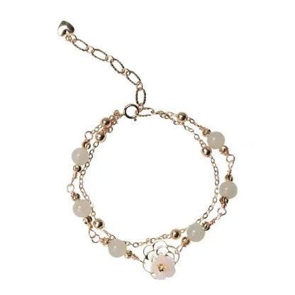 Women's shell flower butterfly bracelet in yellow gold with geometric design and hetian jade style charm.