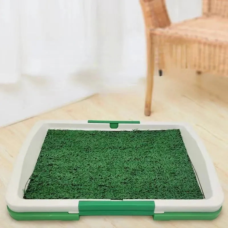 Green synthetic grass indoor dog toilet tray with plastic base for puppy training.
