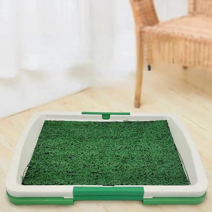 Green synthetic grass indoor dog toilet tray with plastic base for puppy training.