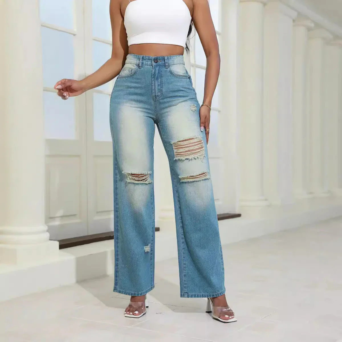 Stylish ripped high-waist jeans with pockets, made from durable denim and cotton-silk blend for comfort and fashion.
