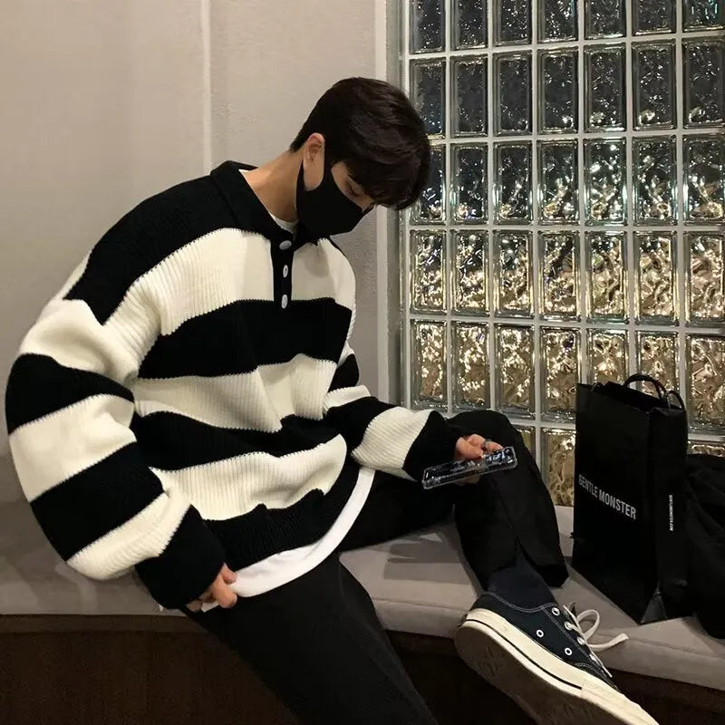 Man wearing a loose-fit black and grey striped polyester pullover sweater