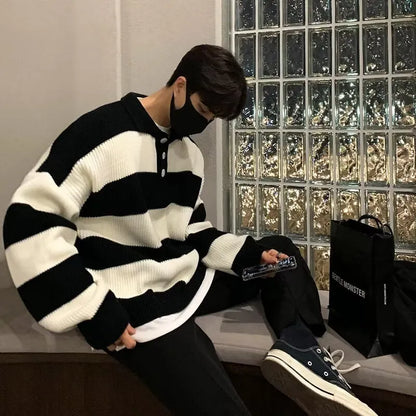 Man wearing a loose-fit black and grey striped polyester pullover sweater